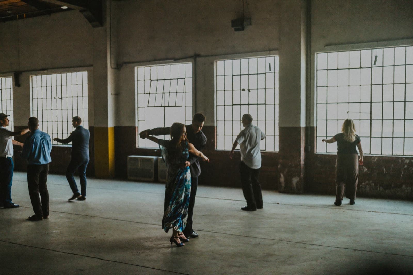 An intimate bachata couple dancing in a modern Rotterdam venue
